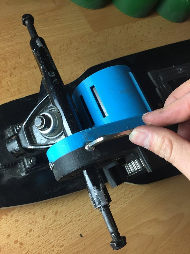 a person is holding the bottom part of a skateboard with blue tape on it