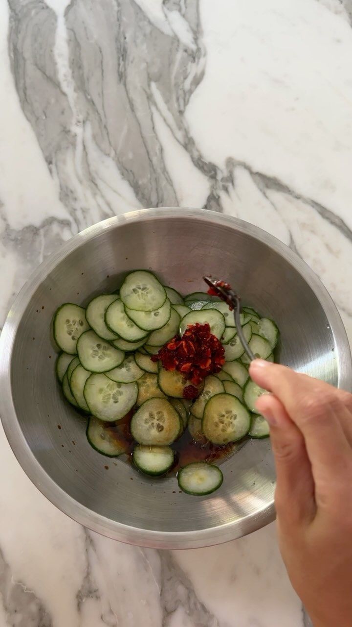 cucumbers in a metal bowl being prepared to be cooked