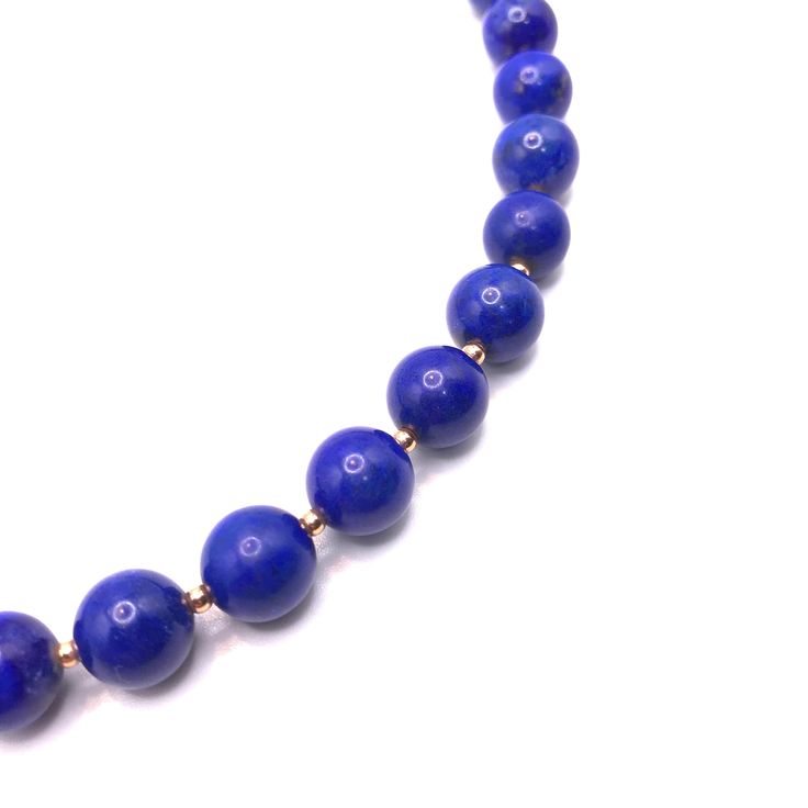 Introducing our striking chunky round lapis beaded collar necklace, a bold and beautiful statement piece that is sure to elevate any outfit. This necklace is handcrafted with reconstituted lapis beads to create a stunning collar design. The 10mm lapis bead size gives the necklace a substantial weight and presence that is both dramatic and eye-catching. The collar design of this necklace sits beautifully around the neck, and the adjustable length ensures a comfortable and custom fit. The bold des Elegant Beaded Necklaces With Round Lapis Lazuli Beads, Formal Lapis Lazuli Necklace With Round Beads, Elegant Lapis Lazuli Beaded Necklaces With Round Beads, Adjustable Lapis Lazuli Beaded Necklace With Polished Beads, Elegant Lapis Lazuli Beaded Necklace With Round Beads, Adjustable Lapis Lazuli Beaded Necklace With 8mm Beads, Necklace With 8mm Round Lapis Lazuli Beads, Formal Lapis Lazuli Beaded Necklace, Adjustable Single Strand Lapis Lazuli Necklace