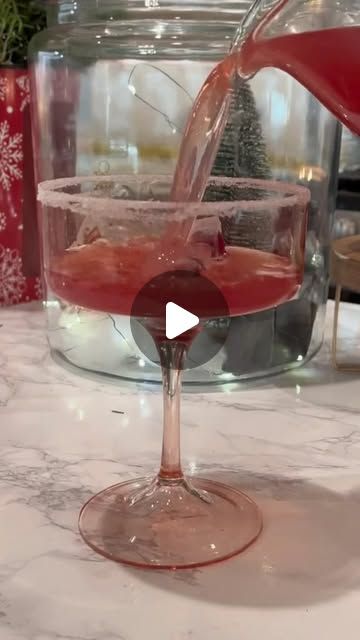 a glass filled with liquid sitting on top of a counter