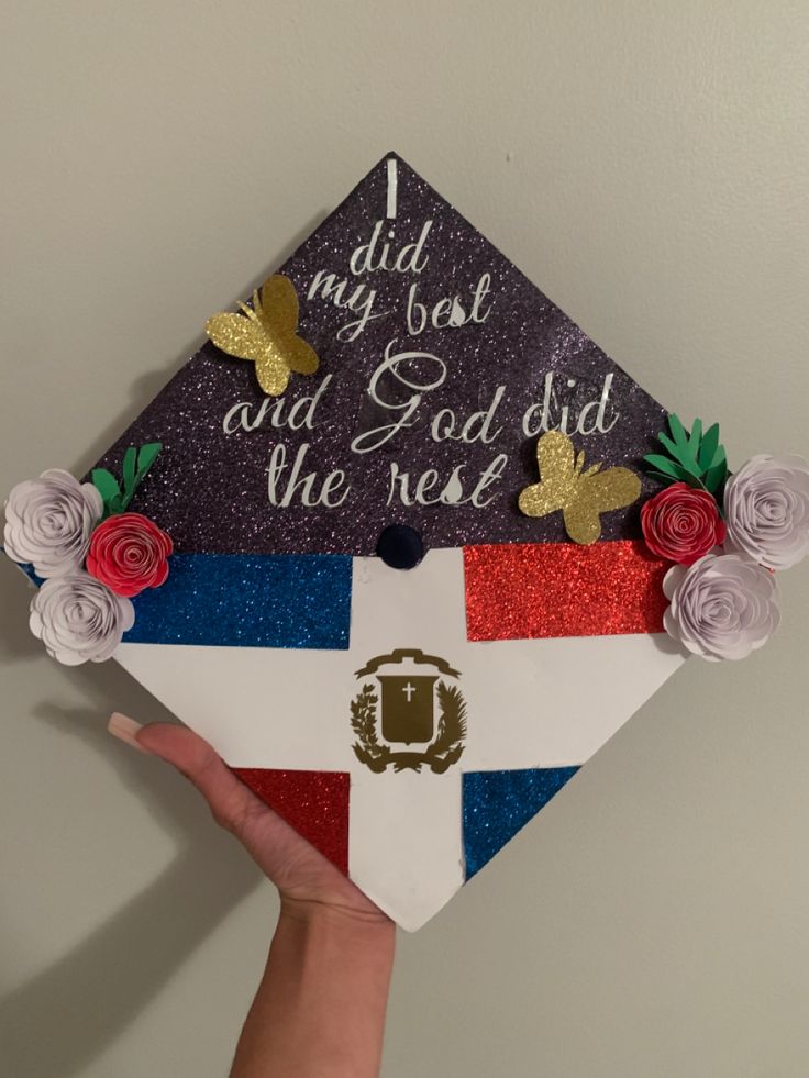 someone is holding up a graduation cap decorated with flowers and glitters that says, i did my best and god did the rest