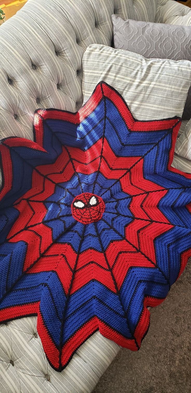 a crocheted spiderman blanket on a couch