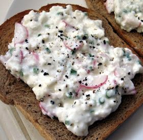 two pieces of bread topped with cream cheese and radishes