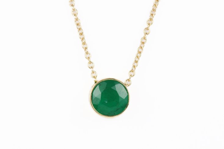 Featured here is a stunning, round emerald pendant in fine 14k yellow gold. Displayed in the center is a medium-green emerald accented by a simple bezel gold mount. The earth mined, green emerald has a desirable lush green color. This emerald is 100% earth mined and is not perfect! Gorgeous flaws are seen within the stone, embrace uniqueness! The chain is attached to this piece, non-removal. Total Carat Weight: 0.90cts Setting Style: Bezel Setting Material: 14K Yellow Gold Main Stone: Emerald Sh Elegant Gold Emerald Necklace, Formal Round Emerald Necklaces, Elegant Green Round Solitaire Necklace, Gold Emerald Birthstone Necklace, Green Gemstone Round Cut Necklace, Elegant Green Round Stone Jewelry, Gold Emerald Round Necklace, Green Gemstone Necklace With Round Cut, Classic Gold Emerald Necklace