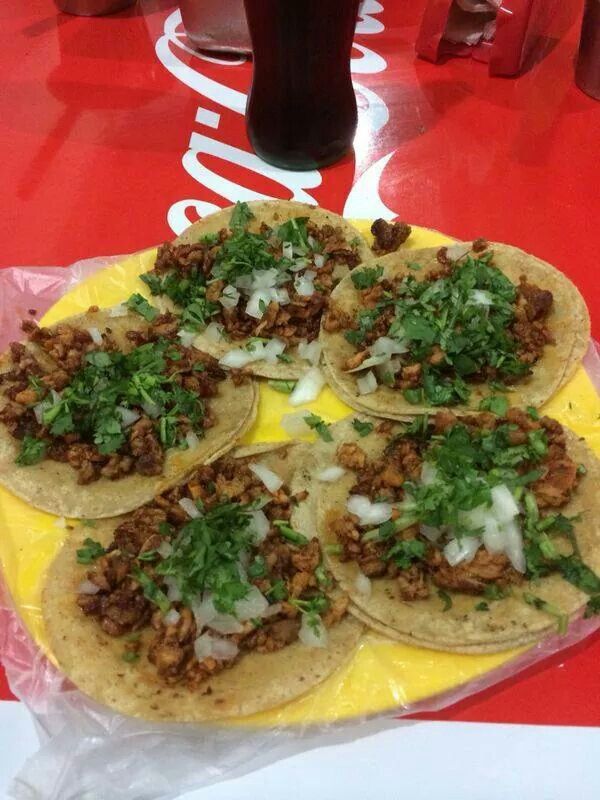 some tacos are sitting on a yellow plate