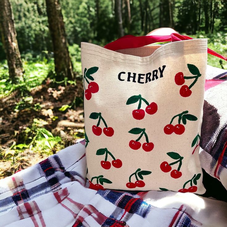 🍒 Cherry Tote Bag with Inside Zipper Pocket 🍒 Welcome to our enchanting collection of handcrafted bags! Each piece is a masterpiece of both style and functionality, designed to meet your diverse needs. 🌟 Discover Unique Handcrafted Bags! 🌟 Explore our range and find the perfect bag for every occasion: 🎁 Perfect Gift: Personalize your bag with initials or a name for a heartfelt touch. Surprise your loved ones with a thoughtful, stylish present! 🎨 Artisanal Designs: Immerse yourself in the c Cherry Tote Bag, Cherry Bag, Canvas Bag Design, Artisanal Design, Handcrafted Bags, Personalized Gifts For Her, Gifts For An Artist, Personalize Bag, Bag Shoulder