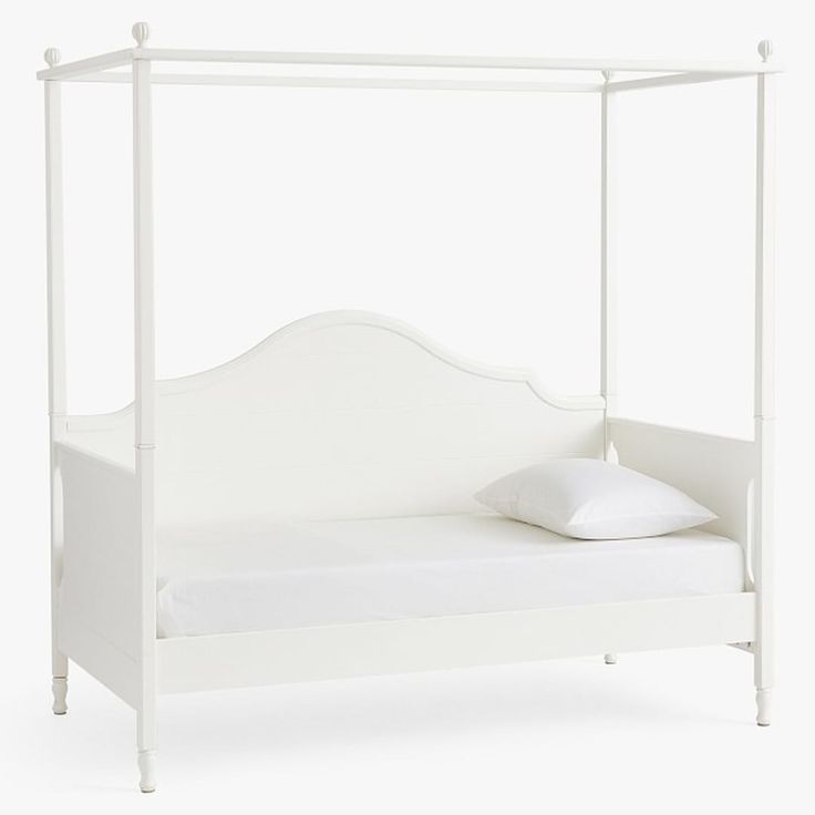 a white bed with a canopy and pillows on it's sides, against a white background