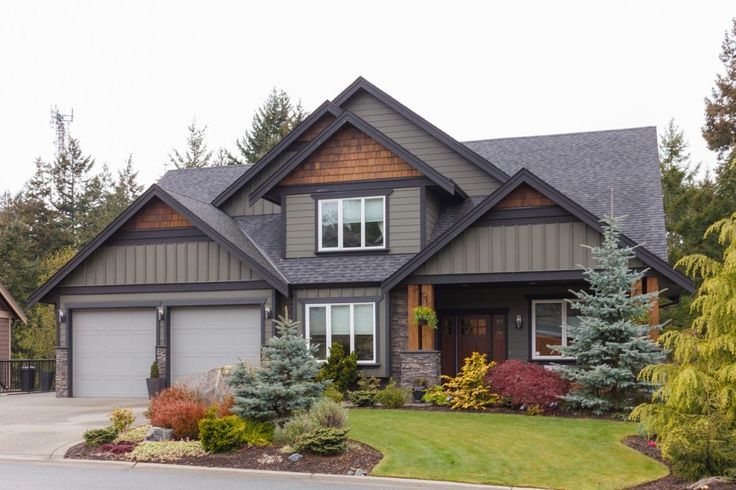 a large house with lots of trees and bushes around it's front entrance area