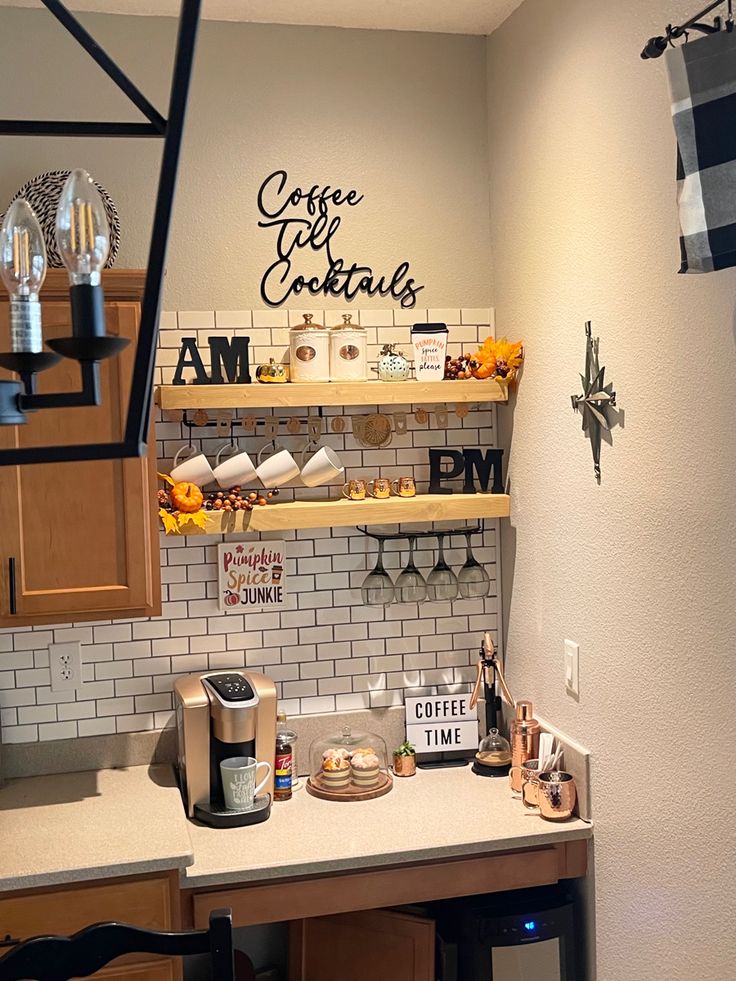 a kitchen counter with coffee cups and other items on the shelves next to it,