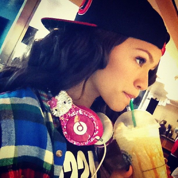 a woman drinking a milkshake and listening to music