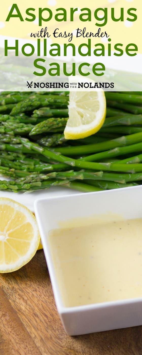 asparagus with easy blender hollandaise sauce in a bowl on a cutting board