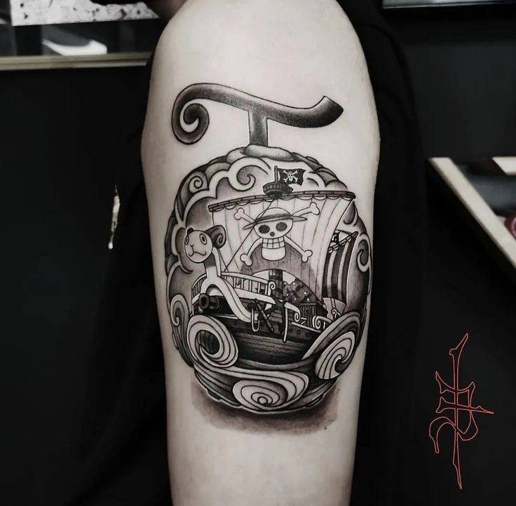 a man's arm with a pirate ship tattoo on it and an anchor in the middle