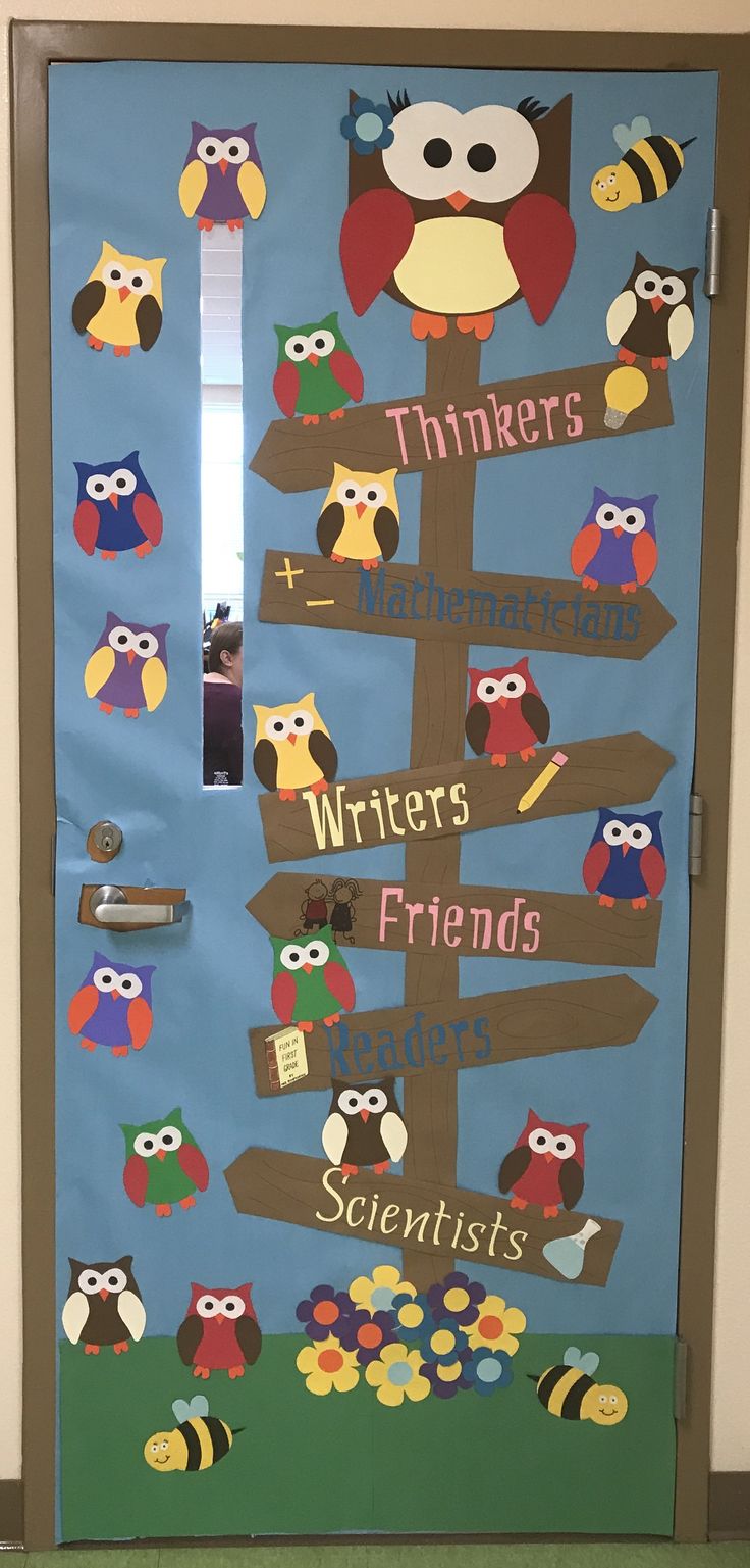 a door decorated with an owl theme and some writing on the front, which is attached to a bulletin board