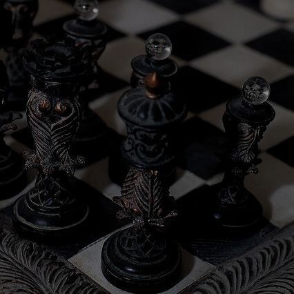 a black and white checkered board with chess pieces