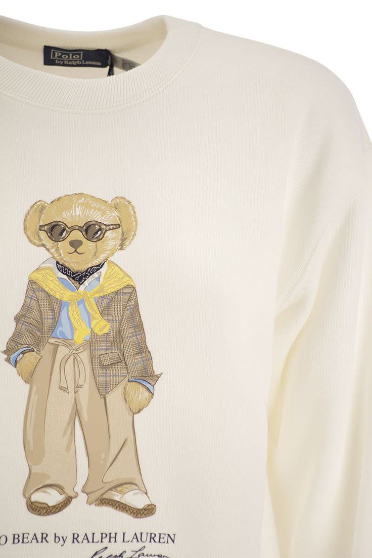 This crewneck sweatshirt features a printed and embroidered version of the iconic Polo Bear in a stylish and exclusive Ralph Lauren seasonal outfit. - Soft cut - Hip length - Crew neck - Long sleeves with ribbed cuffs - Low shoulders - Ribbed hem - Polo Bear, "Polo Bear by Ralph Lauren" and "Ralph Lauren" signature printed on centre front - Embroidery on Polo Bear DESIGNER ID: 211924298 001Gender: WomenMaterial: 84% COTTON, 16% POLYESTERColor: CREAMMade in: VNProduct ID: 211924298 001*Import tax Polo Bear Ralph Lauren Outfit, Polo Bear Outfit, Polo Bear By Ralph Lauren, Polo Bear Ralph Lauren, Fun Fits, Ralph Lauren Bear, Bear Outfit, Soft Cut, Polo Ralph Lauren Sweatshirt