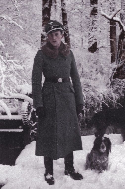 a woman standing next to a dog in the snow