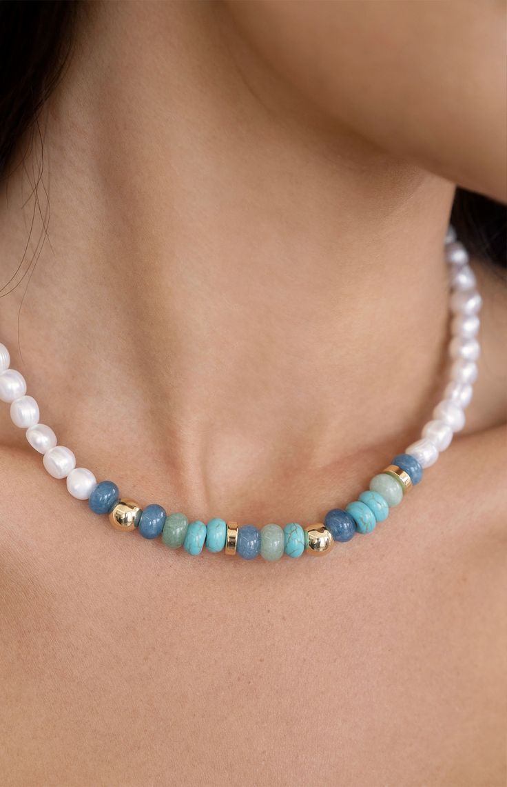 Online Only! Capture the essence of a perfect beach day with Ettika's Beach Day Pearl & Blue Gemstone Necklace, featuring a faux pearl beaded design adorned with gold, turquoise, and mixed gemstone beads. This necklace radiates coastal charm and elegance, making it an ideal accessory for summer adventures and casual outings alike.


	18k gold plated
	Freshwater pearls
	Mixed blue gemstones
	15" with 3" extender
	Lobster clasp closure Beach Jewelry With Pearl And Gemstone Beads, Beach Pearl Jewelry With Gemstone Beads, Pearl Jewelry With Gemstone Beads For Beach, Vacation Beaded Pearl Necklace, Pearl Necklaces With Spacer Beads For Beach, Beach Pearl Beaded Necklaces With Spacer Beads, Pearl Beaded Necklaces With Spacer Beads For Beach, Round Pearl Bead Jewelry For Vacation, Turquoise Round Beads Pearl Necklace For Beach