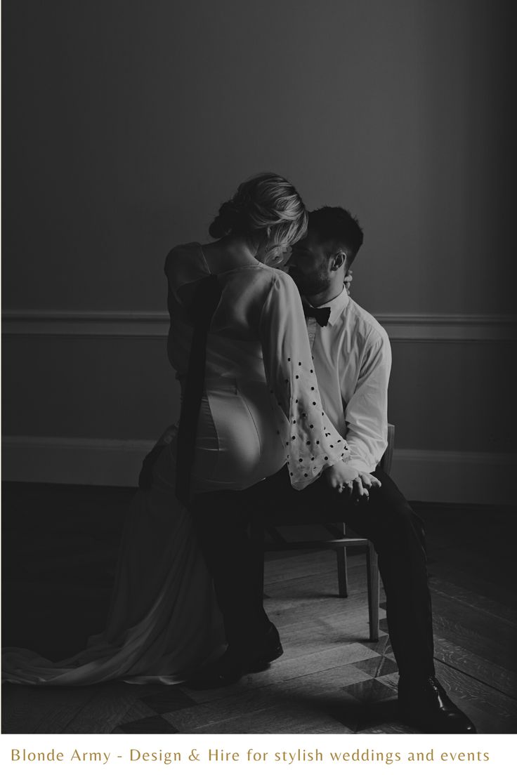 black and white photo of couple sitting on chair