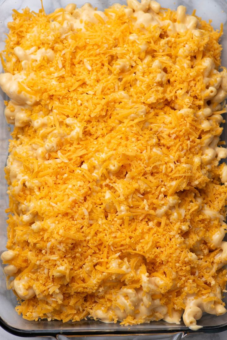 a casserole dish filled with macaroni and cheese in a glass pan