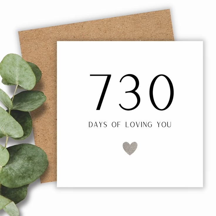 a white card with the number seventy days of loving you written on it next to some green leaves