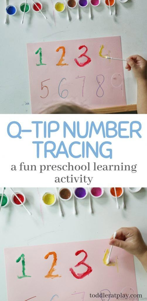 two children's hands are painting numbers on paper