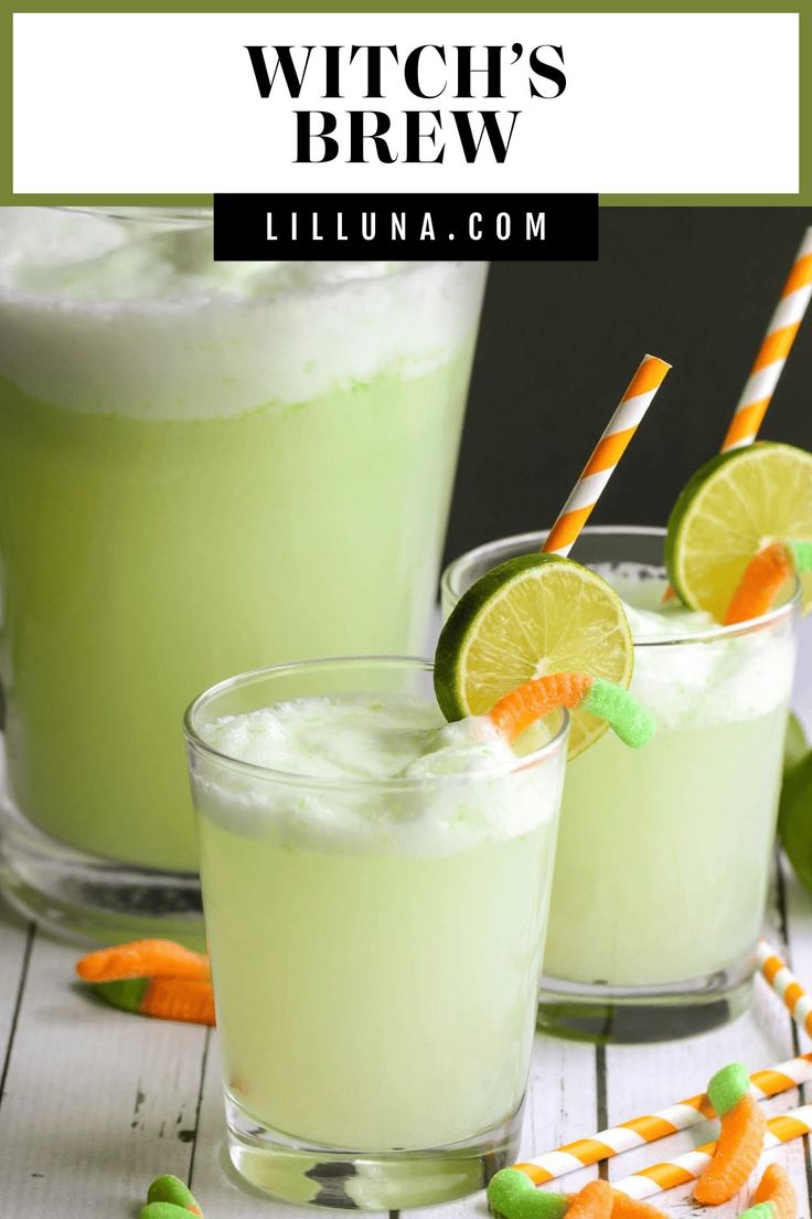 two glasses filled with limeade and candy on top of a white wooden table next to orange and green striped straws