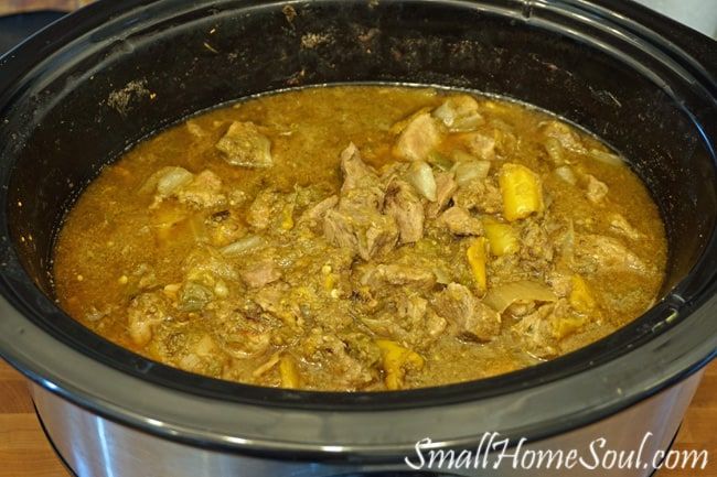 a slow cooker filled with meat and vegetables