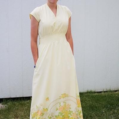 a woman in a white dress standing on grass