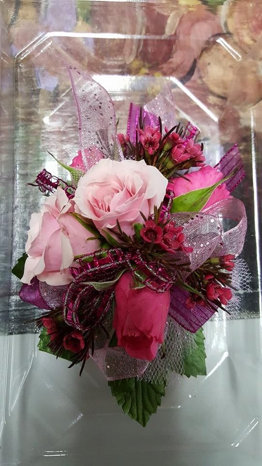 a bouquet of pink flowers in a clear box