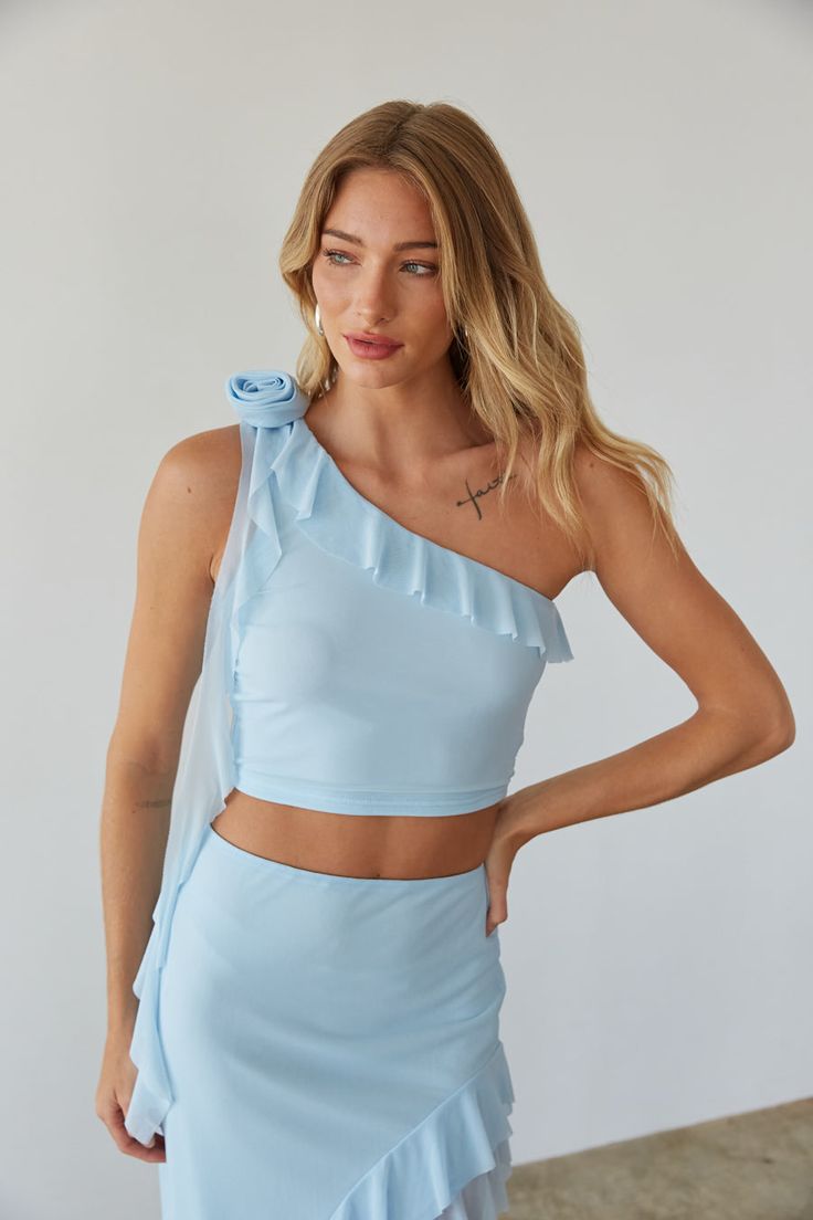 Stay vacation-ready in the Carissa Asymmetrical Ruffle Rosette Top! This one-shoulder crop top features a rosette embellishment on the right shoulder, ruffle neckline, and cascading ruffle drape. Pair this unique summer top with the Carissa Asymmetrical Ruffle Maxi Skirt for the perfect Summer vacation outfit! Details: Self: 90% Polyester, 10% Spandex Lining: 100% Polyester Lots of stretch Fully Lined Hand wash cold/ Lay flat to dry