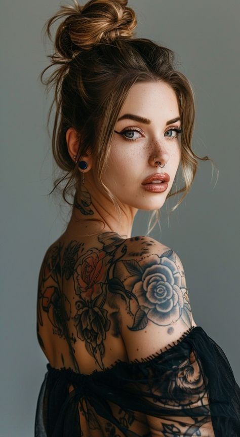 a woman with tattoos on her back and shoulder is posing for the camera, wearing a sheer black dress