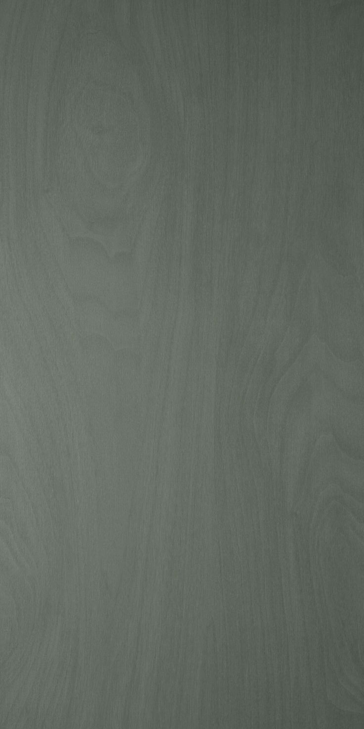 a black and white photo of a wood grain surface with some light green paint on it