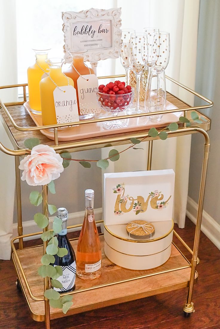 a gold bar cart filled with drinks and condiments