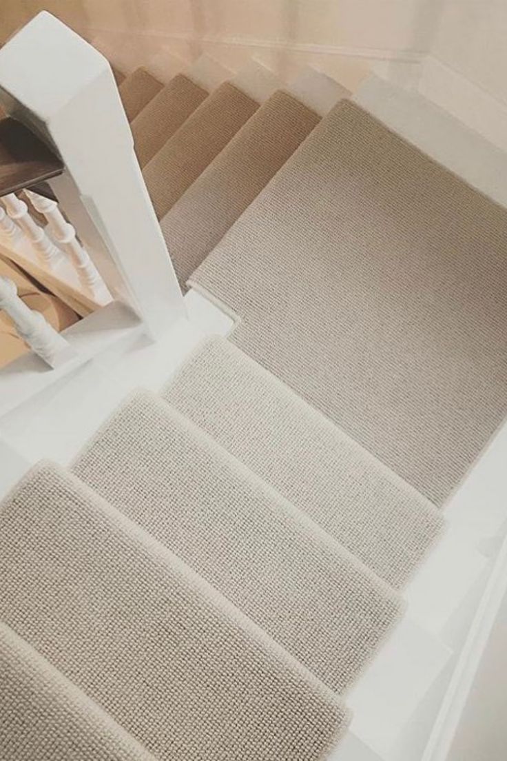 the carpet is being laid out on the stairs