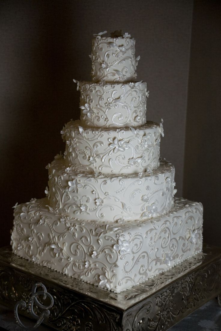 a large white wedding cake sitting on top of a table