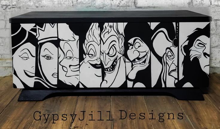 a black and white cabinet with faces painted on it