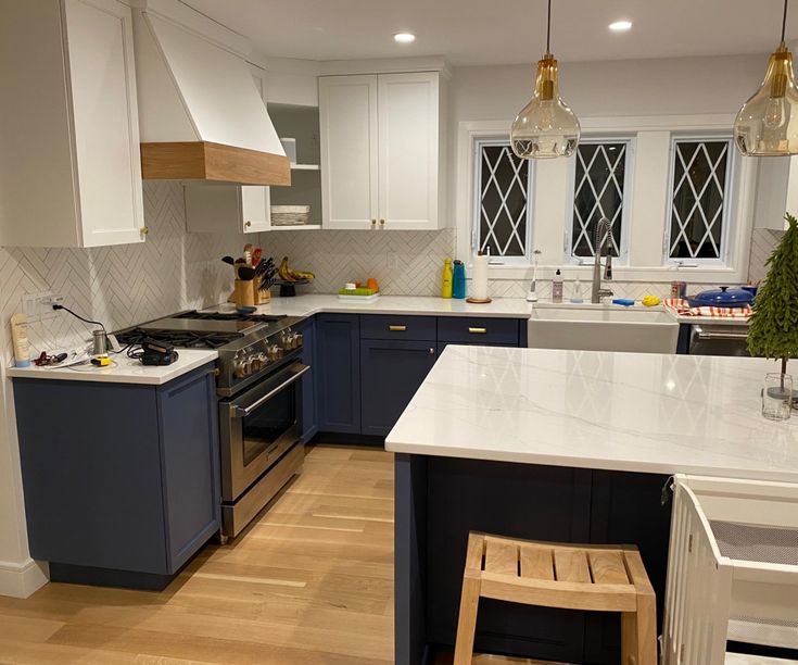 a kitchen with an island, stove and sink in it's center area is shown