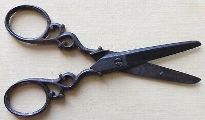 an old pair of scissors sitting on top of a table