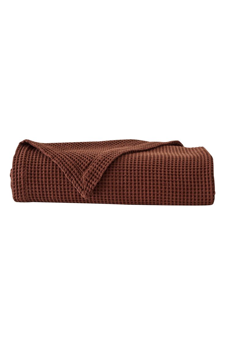 a brown towel folded on top of a white background