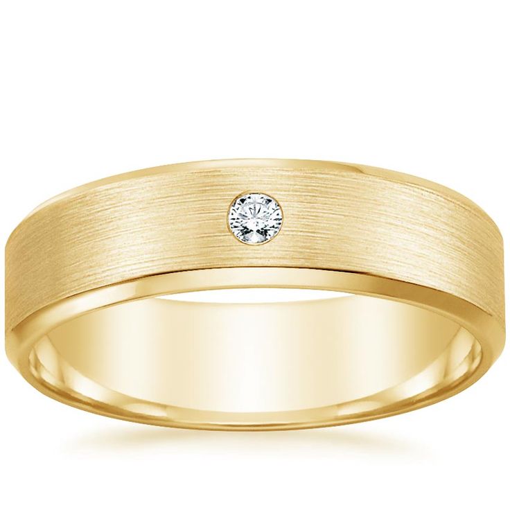 a yellow gold wedding ring with a diamond