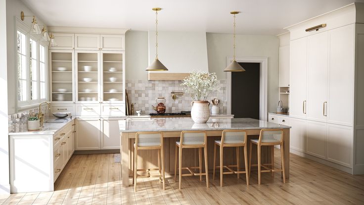 a kitchen with wooden floors and white cabinets, an island countertop and stools