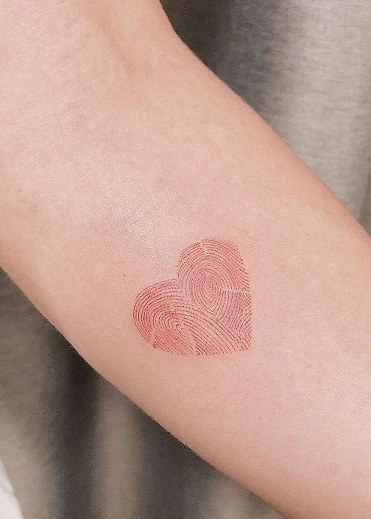 a fingerprint in the shape of a heart on someone's left arm,