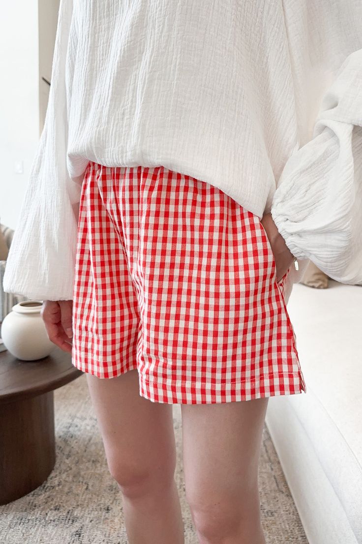 Shorts with so many charming details! The Sky Gingham Shorts in Red can easily be mixed and matched with all of our summer pieces! Featuring side and back pockets, gingham pattern, red and off white colors, woven fabric, lining throughout, elastic waistband and a true to size fit. Style these cute shorts with a basic cream tank or tee! Details & Sizing Side and back pockets Red and off white gingham Lining throughout Elastic waistband True to size fit Gabriella is wearing a size S Fabric Self: 5 Summer Gingham Bottoms With Elastic Waistband, Gingham Bottoms For Summer Picnic, Summer Plaid Bottoms For Picnic, Summer Plaid Bottoms For Day Out, Plaid Bottoms For Summer Picnic, Casual Shorts With Elastic Waistband For Picnic, Gingham Bottoms With Pockets, Gingham Short Bottoms With Pockets, Gingham Bottoms With Pockets For Picnic