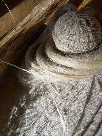 two balls of yarn sitting on top of a bed