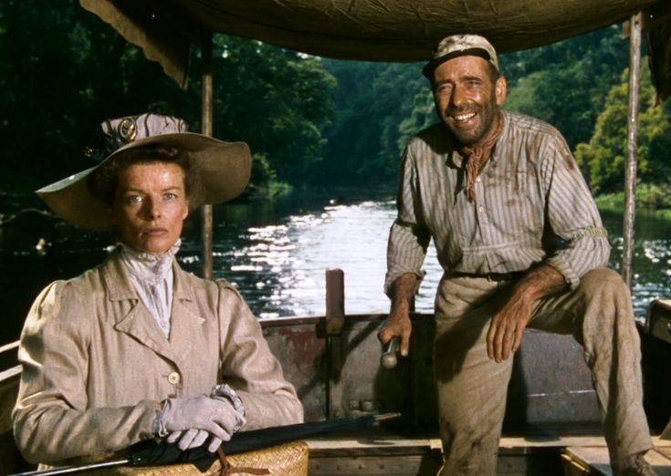 two people sitting on a boat in the water