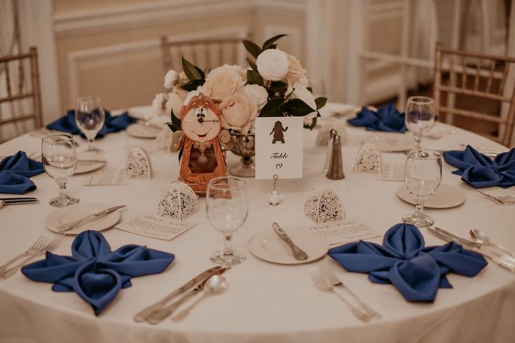 the table is set with blue napkins and silverware