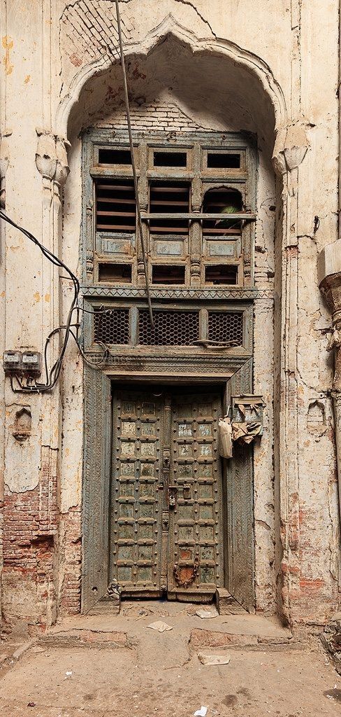 an old building with two wooden doors