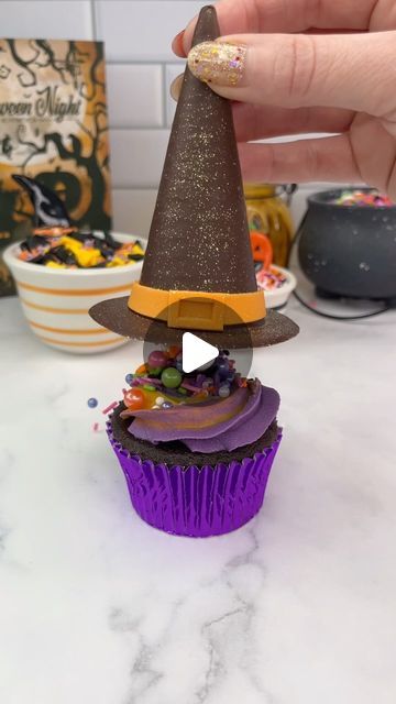 a cupcake with a witches hat on top