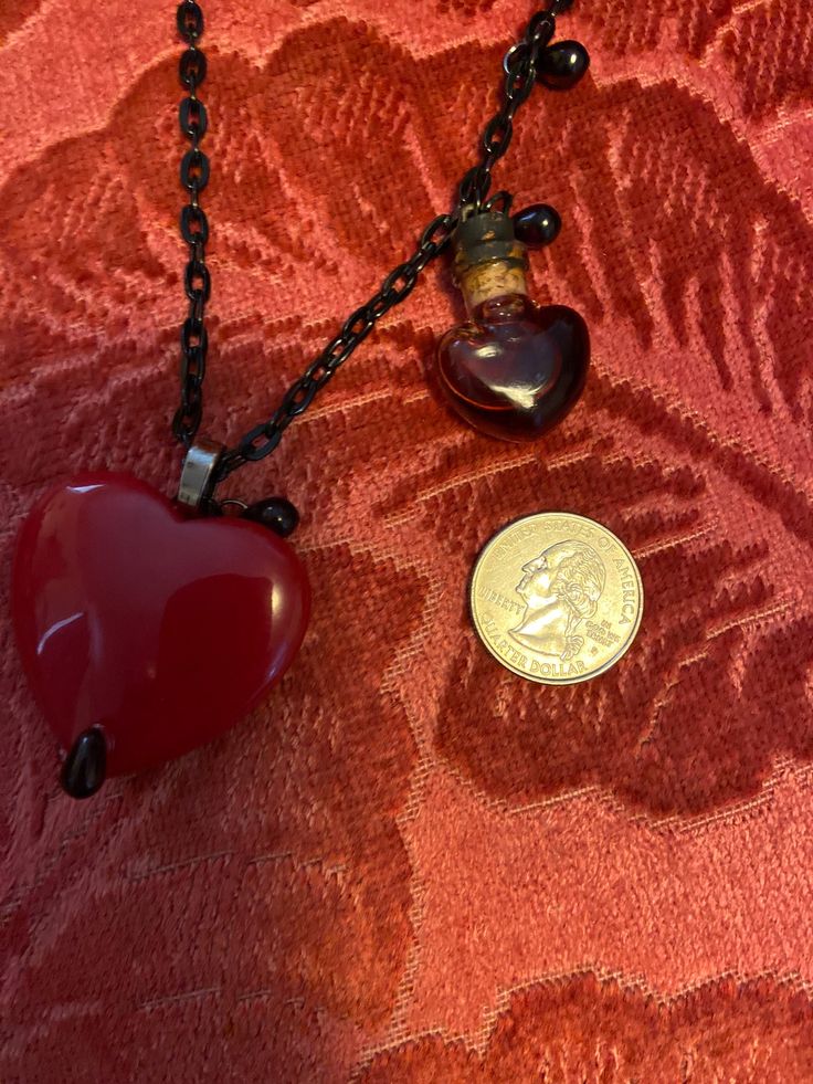 "Natural Red Jade, Bleeding Heart Necklace... With Blood Potion Bottle Red Jade The most Passionate and Stimulating Stone, A Stone of Love, and encouraging Love Energies.. Wear Red Jade to increase your Abundance, and Prosperity.. Leadership skills enhanced.. Ultimate Protection Their beautiful Natural Red Jade Is Big, measures 40mm The Black Stainless Steel Chain ( adjustable ) Measures 26\" With Glass.. Blood Drops" Vintage Red Heart-shaped Necklace, Red Double Heart Necklace For Wedding, Vintage Red Heart Necklace, Wedding Double Heart Red Necklace, Wedding Red Double Heart Necklace, Red Pendant Necklace For Keepsake, Red Spiritual Necklace For Valentine's Day, Spiritual Red Necklace For Valentine's Day, Red Keepsake Pendant Necklace