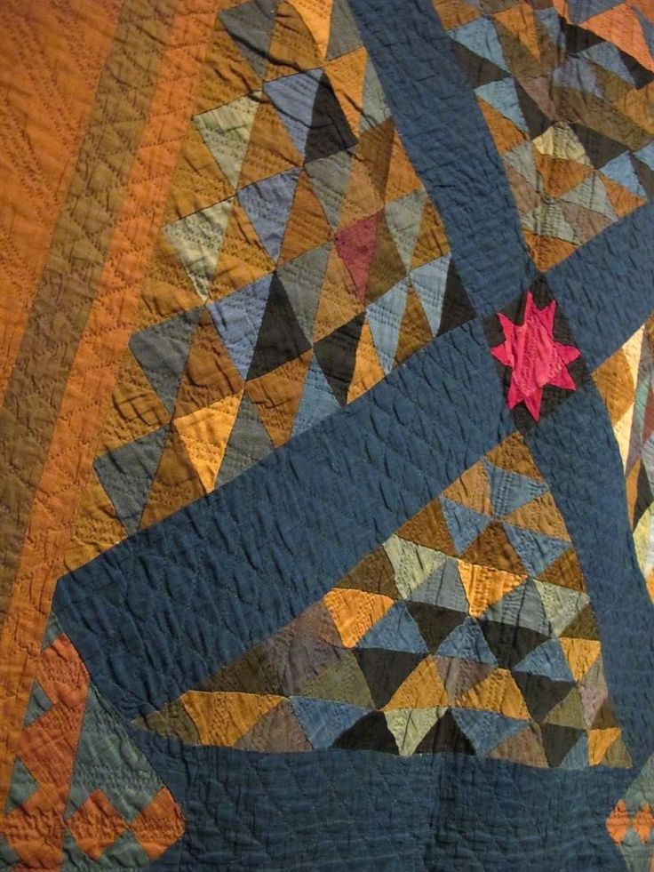 a quilt with an orange star on it